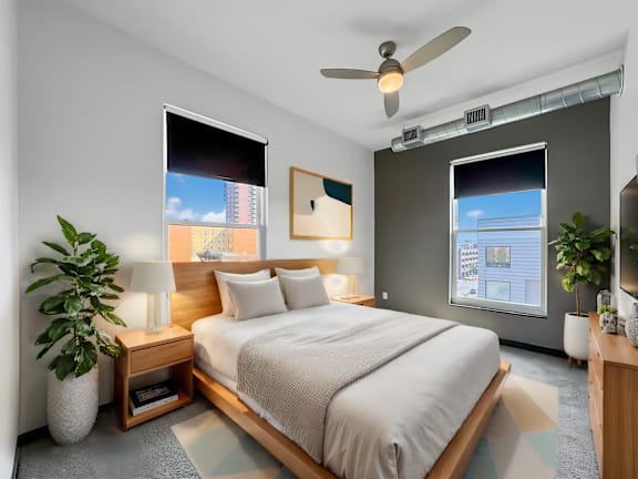 a bedroom with a large bed and a ceiling fan