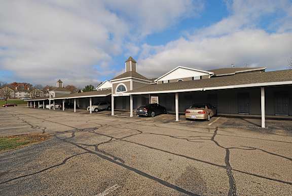 A parking lot with a building in the background.