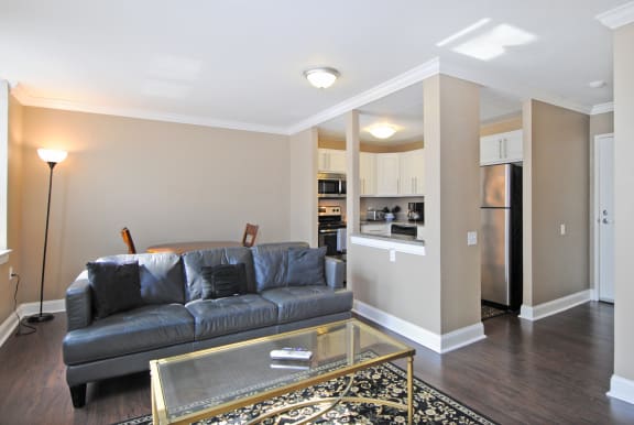 a living room with a couch and a glass coffee table