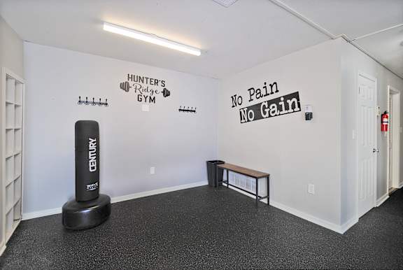 A gym with a bench and a weight machine.