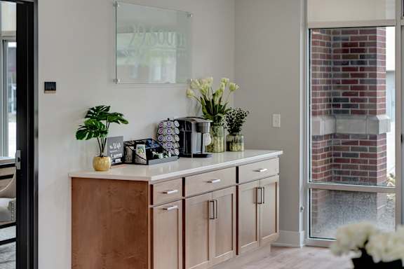 a kitchen with wooden cabinets and a counter with vases and flowers