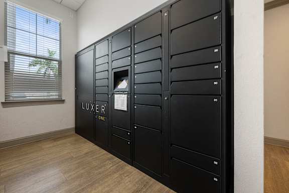 A black filing cabinet with the word LUXER on it.