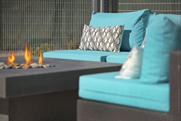 a living room with blue couches and a fire pit at Novella Arcadia, Arizona