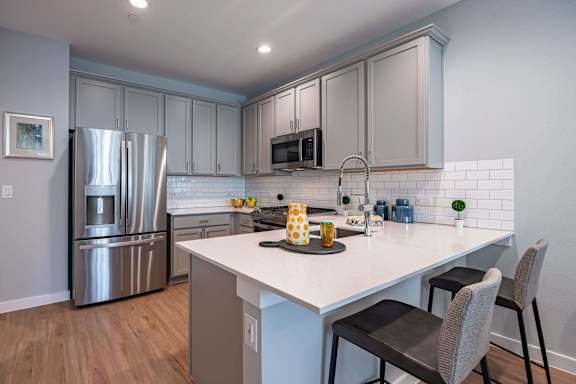 Fitted Kitchen With Island Dining at Villae ATX Luxury Rental Townhomes, Manchaca, TX
