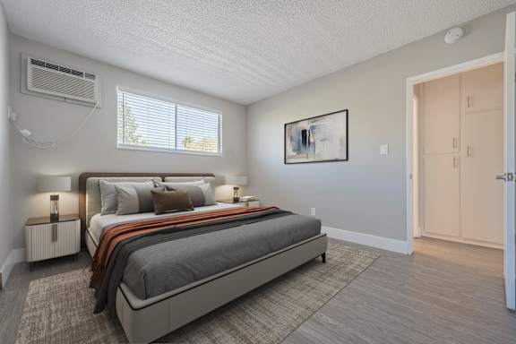 A bedroom with a large bed and a painting on the wall.