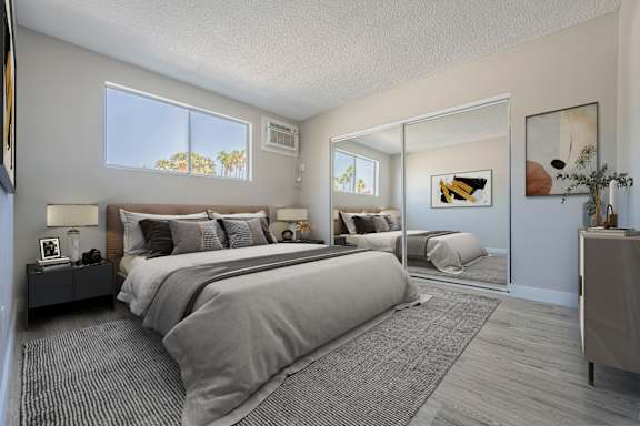 A bedroom with a large bed and a mirror on the wall.