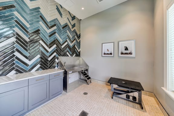 a modern bathroom with a chevron tile accent wall