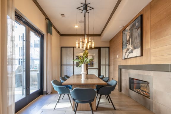 a dining room with a wooden table and chairs and a fireplace