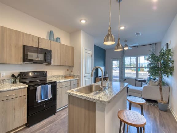 a kitchen with an island and a stove and a sink