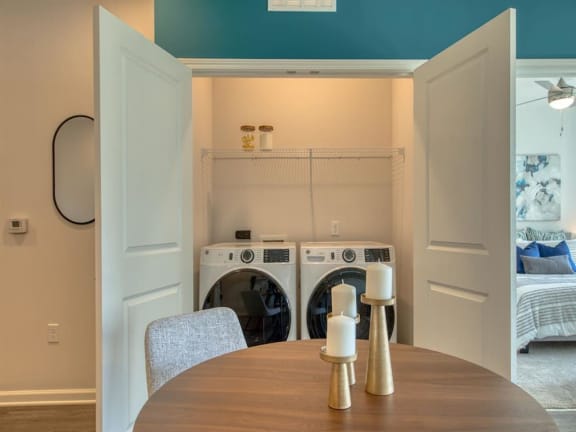 a laundry room with a table and chairs and a washing machine