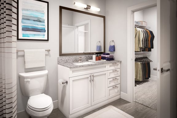 a bathroom with a white toilet next to a white sink with a mirror above it and a