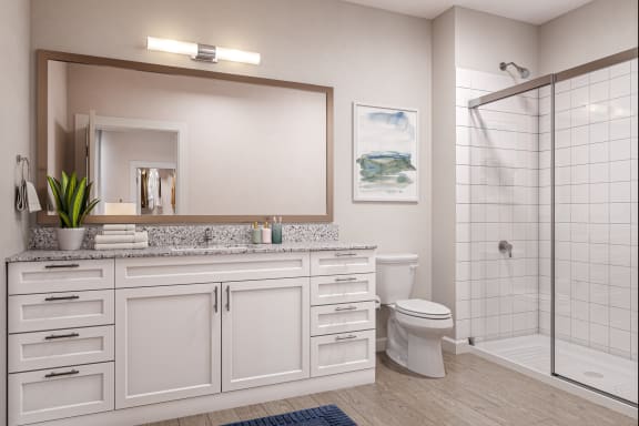 a bathroom with a large mirror and white cabinets
