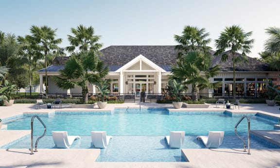a resort style pool with lounge chairs and palm trees in front of a building