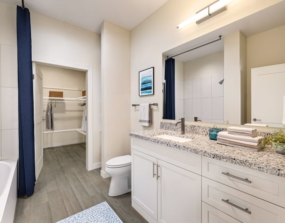 a bathroom with a large mirror and a toilet and a shower