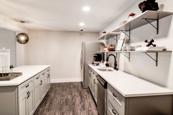 a kitchen with white countertops and stainless steel appliances at Hamilton at Kings Place, Columbia Maryland