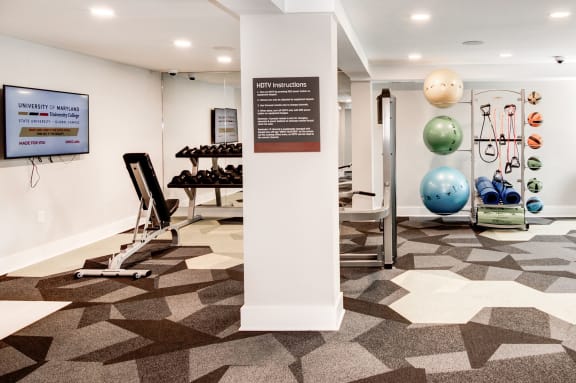a view of the fitness center with weights and other exercise equipment at Hamilton at Kings Place, Columbia, MD