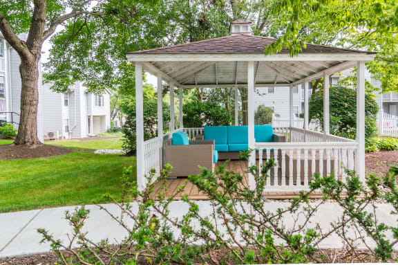 a white gazebo with a blue couch on it at Hamilton at Kings Place, Maryland, 21046