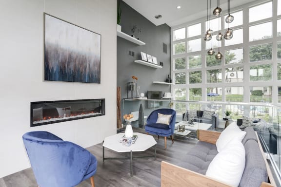 a living room with a large window and a fireplace at Madison at Eden Brook, Columbia, MD