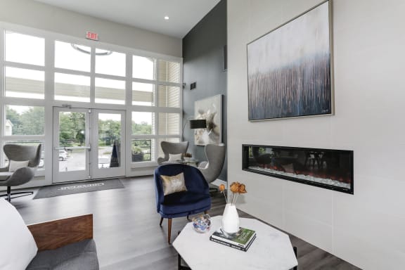 a living room with a blue chair and a white coffee table at Madison at Eden Brook, Columbia, 21046
