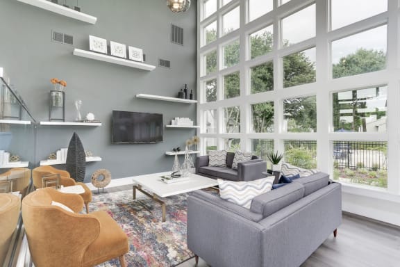 a living room with a large wall of windows at Madison at Eden Brook, Columbia, MD 21046