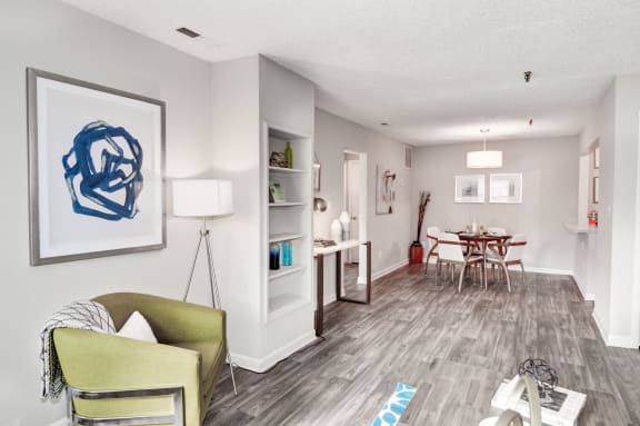 a living room with a couch and chair and a dining room table in the background at Hamilton at Kings Place, Columbia Maryland