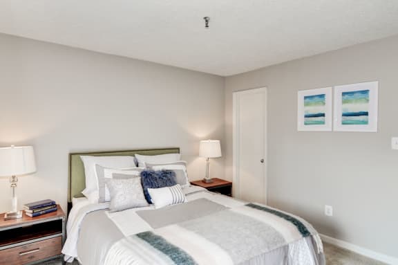a bedroom with a bed and two night stands at Hamilton at Kings Place, Columbia