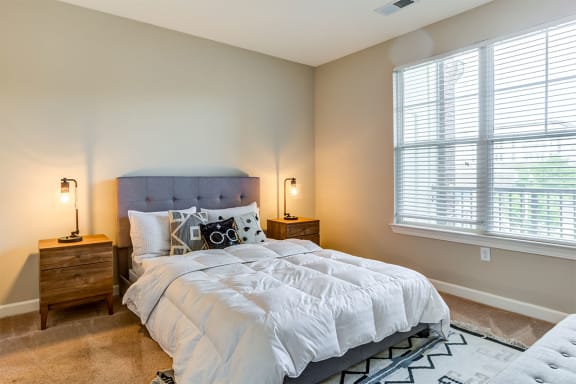 a bedroom with a bed and two night stands at Aspire Apollo, Maryland