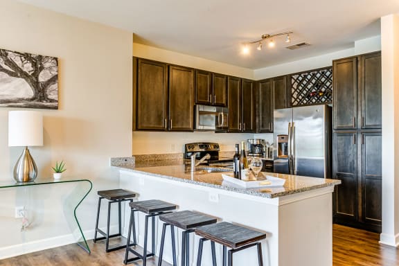 a kitchen with a breakfast bar and stainless steel appliances at Aspire Apollo, Camp Springs, 20746