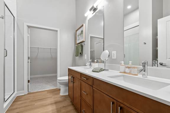 A bathroom with a white toilet and a white sink.