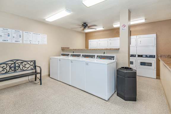 A room with a bench, a trash can, and a wall with a list of items on it at Riviera Park, Chandler Arizona