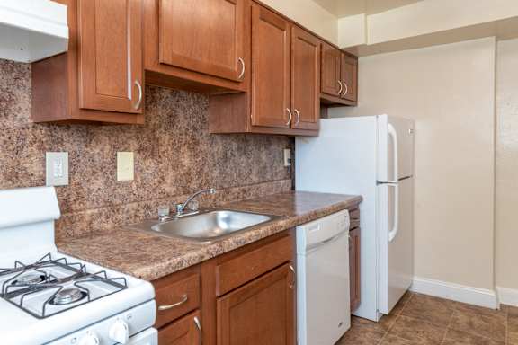 A kitchen with a sink and a stove and a refrigerator at Hamilton Manor Apartments, Hyattsville, MD, 20782