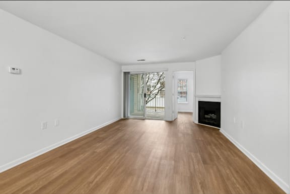 Empty living room with fireplace at Park at Winterset Apartments, Owings Mills, 21117