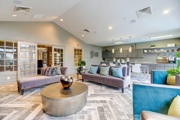 a living room with couches and a table at MetroPlace at Town Center, Camp Springs, MD