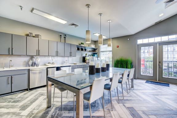 a large kitchen with a long table and chairs at MetroPlace at Town Center, Camp Springs, MD, 20746