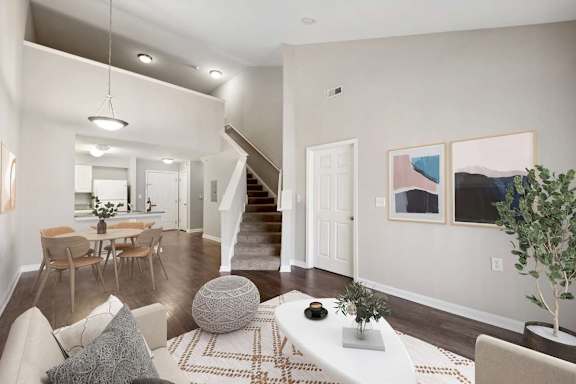 A living room with a white couch and a rug.