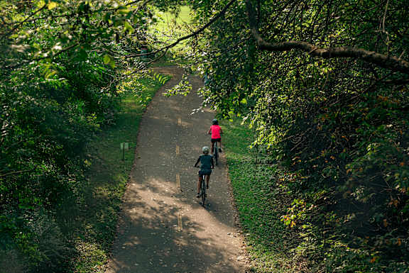 Two people riding bikes at The Terrace Apartments, Maryland, 21701