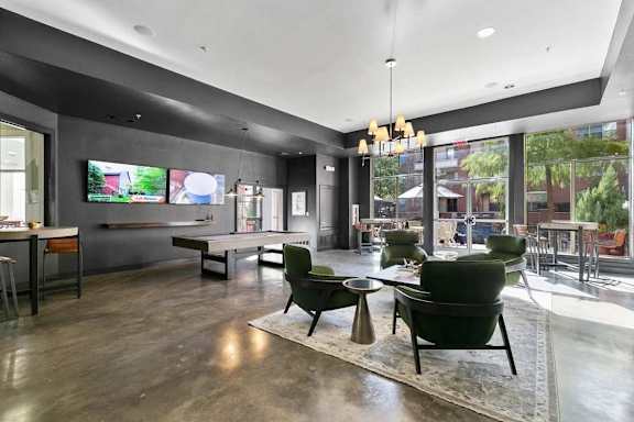 A modern living room with a large window overlooking a city street.