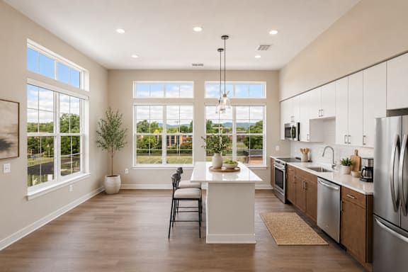 A modern kitchen with a large island and a view of the outdoors.