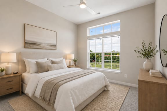 A bedroom with a large bed, a painting on the wall, and a window with a view of the outside.