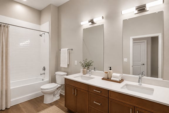 A bathroom with a white toilet, a white sink, and a white bathtub.
