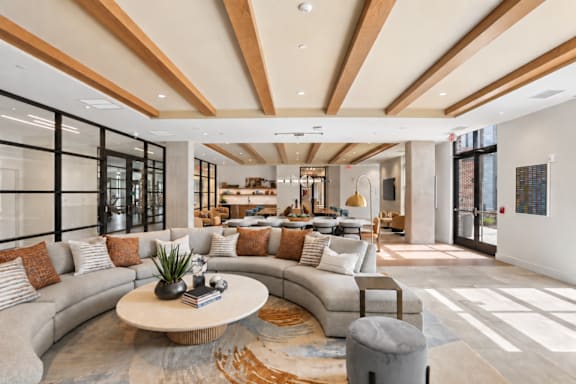 A modern living room with a curved sofa and a coffee table.