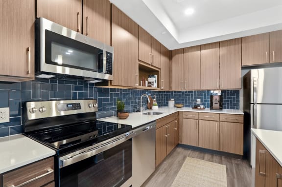 Fully Equipped Kitchen Includes Frost-Free Refrigerator, Electric Range, &amp; Dishwasher at Woodmore Apartments, Maryland, 20706