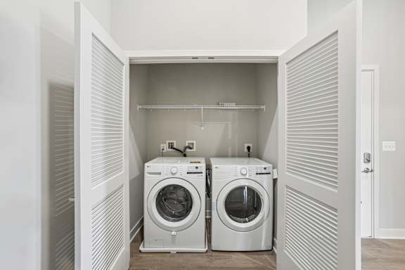 Two front loading washing machines in a laundry room.