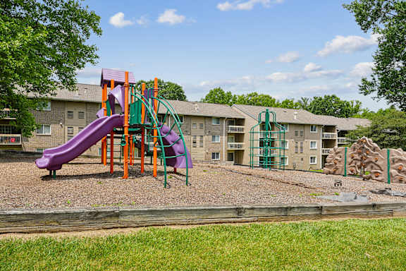 Colorful playground with slides and climbing wall at The Brook At Columbia Apartments, Columbia, MD 21044