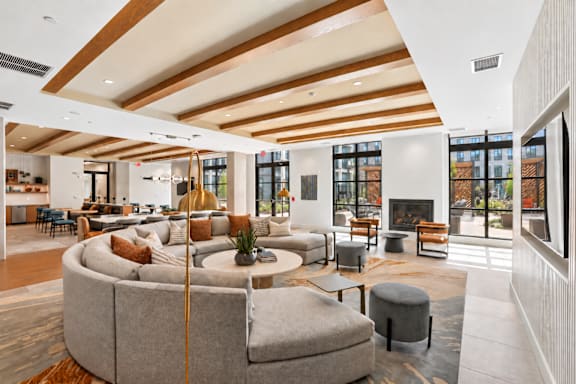 A modern living room with a curved sofa and a fireplace.