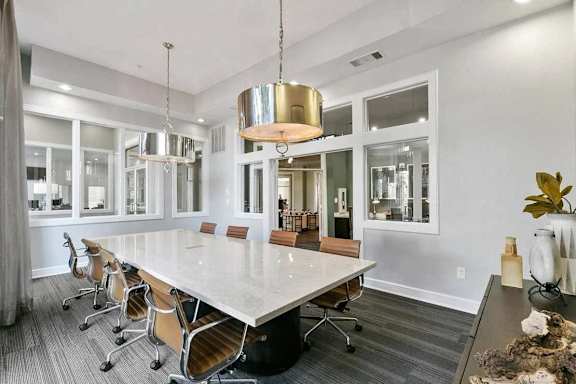 A conference room with a long table and chairs.