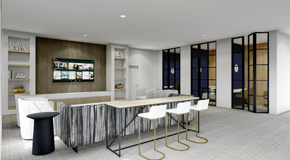 A modern office space with a long table and chairs, a television on the wall, and a cabinet with shelves.