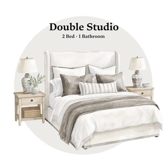 A bedroom with a bed, nightstands, and lamps.