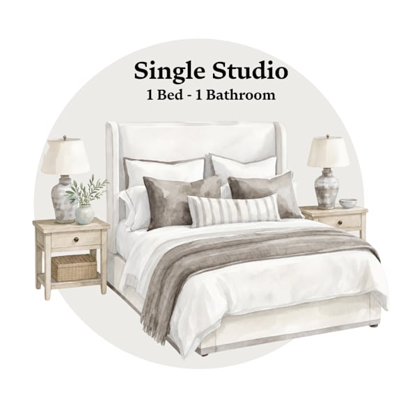 A bedroom with a bed, nightstands, and lamps.