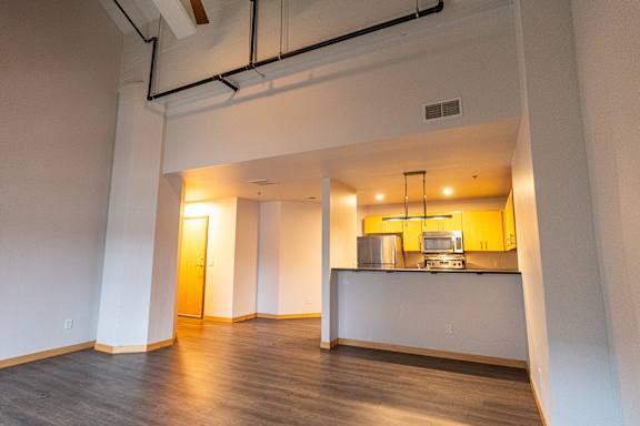 A kitchen area with a counter and a microwave.